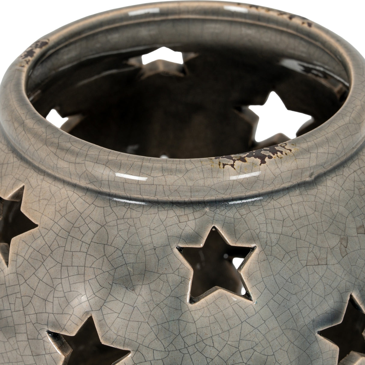 Close-up of the Hill Interiors Large Star Candle Lantern in grey, showing the crackle-glazed ceramic surface and star-shaped cut-outs around the rim.