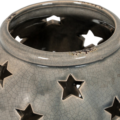 Close-up of the Hill Interiors Large Star Candle Lantern in grey, showing the crackle-glazed ceramic surface and star-shaped cut-outs around the rim.