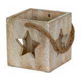 Hill Interiors washed wood tealight holder in white with cube form, star cut-outs on the sides and a jute rope handle, on a plain background.