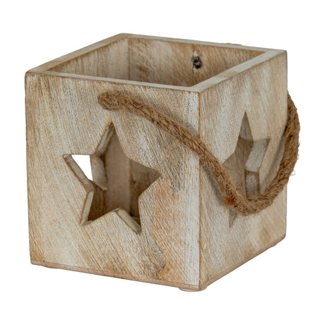 Hill Interiors washed wood tealight holder in white with cube form, star cut-outs on the sides and a jute rope handle, on a plain background.