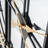 Close-up of Hill Interiors Black and Gold Round Wall Clock 113cm showing gold hands, black centre disc and metal frame against a light background.