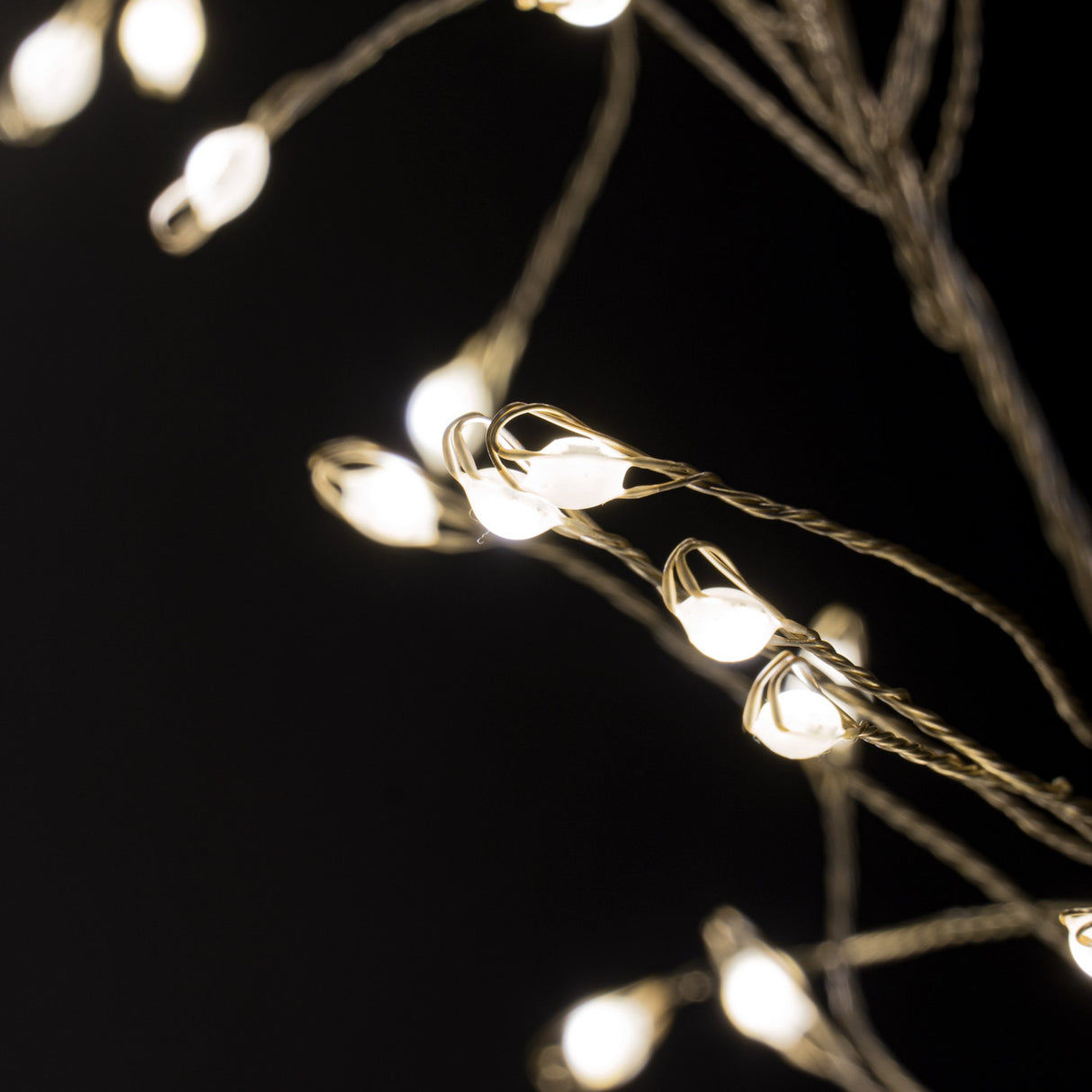 Close-up of Hill Interiors 2.75m plug-in LED cluster string lights, showing warm white bulbs densely gathered along fine wire against a black background.