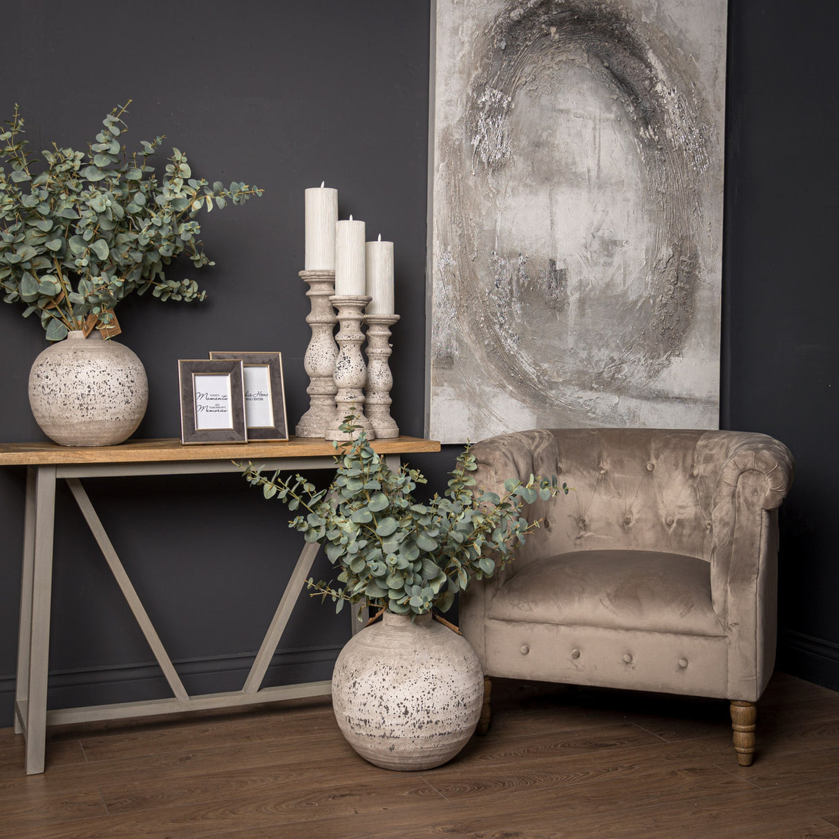 Hill Interiors Stone Ceramic Vase in beige with a rounded textured body, styled with eucalyptus stems beside a console table and velvet armchair.