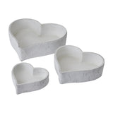 Hill Interiors set of three matt white ceramic heart-shaped decorative bowls in graduated sizes, shown on a plain white background.