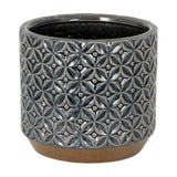 Hill Interiors 15cm ceramic planter with embossed geometric floral pattern in glossy grey, set on an unglazed natural clay base against a white background.