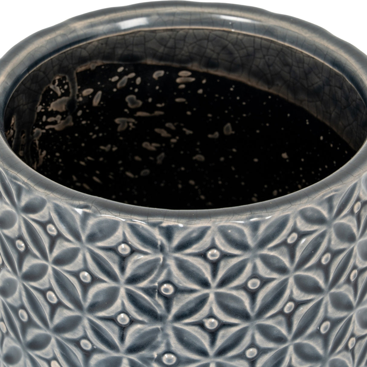 Close-up of Hill Interiors Ceramic Planter 15cm showing embossed geometric floral pattern in glazed grey with a dark speckled interior.