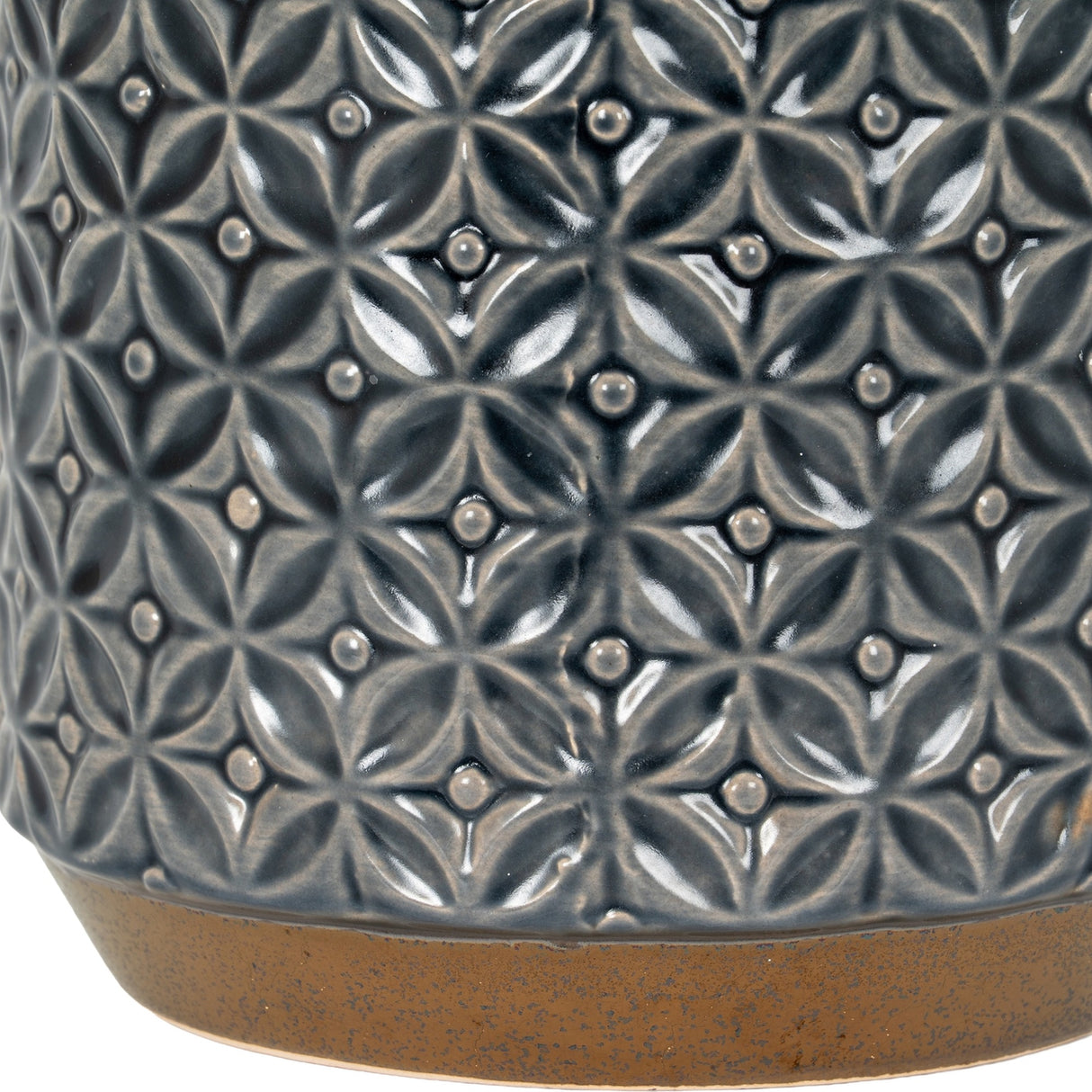 Close-up of Hill Interiors Ceramic Planter 15cm showing embossed geometric floral pattern in glazed dark grey with a natural unglazed base rim.