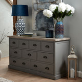 Hill Interiors Large Indigo Scalloped Ceramic Vase holding white hydrangeas on a grey sideboard, styled beside a blue lamp and abstract artwork.