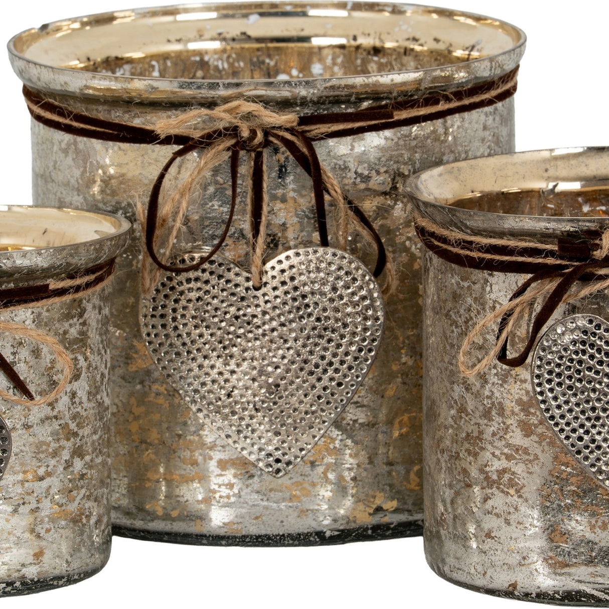 Hill Interiors mercury glass heart candle holders in silvered mottled finish, tied with jute twine and hammered metal heart charms, shown grouped together.