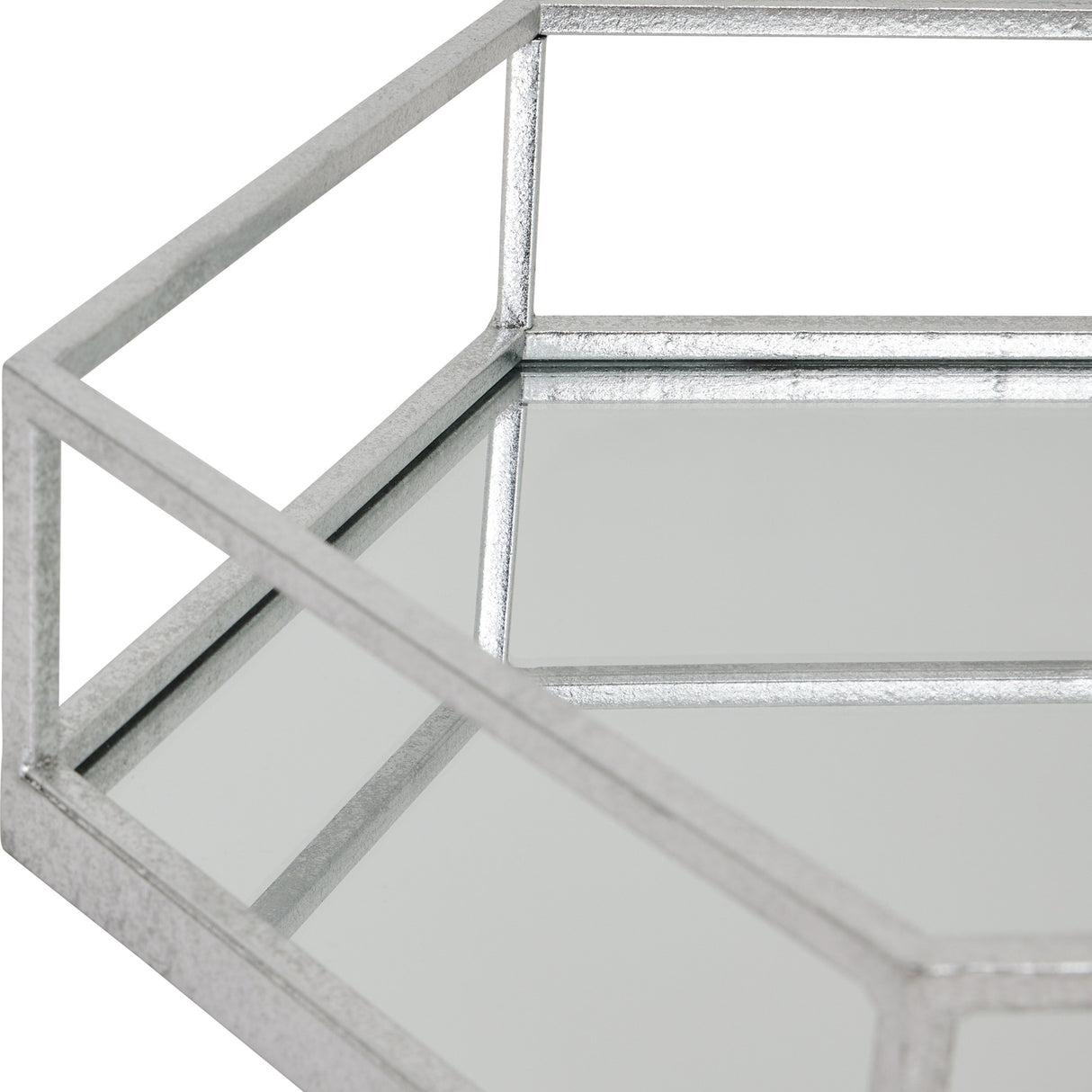Close-up of Hill Interiors Hexagon Glass Serving Tray in silver, showing the angular six-sided frame and mirrored surface against a white background.