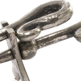 Close-up of the Hill Interiors Antique Pewter Crook Handled Hearth Tidy, showing the arched metal handle and pin detail in a weathered silver finish.
