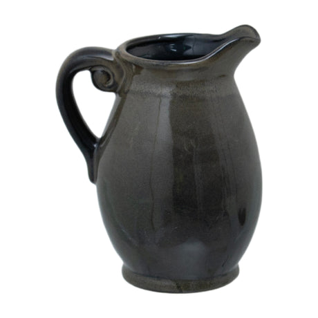 Hill Interiors 22cm green ceramic Olpe vase, a rounded jug-form vessel with curled handle, narrow spouted neck and glossy glaze, on a white background.