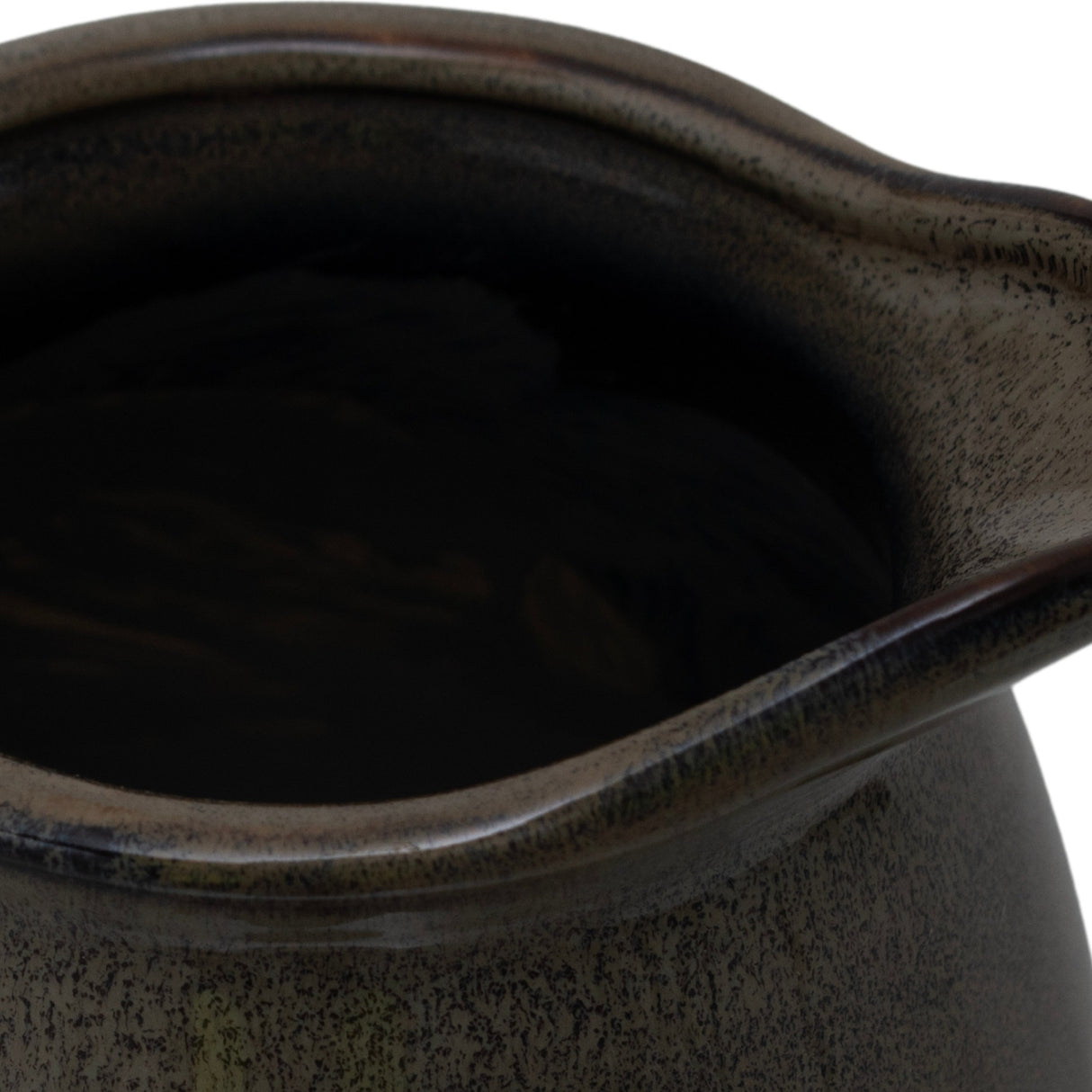 Close-up of the Hill Interiors Ceramic Olpe Vase 22cm in green, showing the wavy rim and mottled glaze pooling across the curved neck.