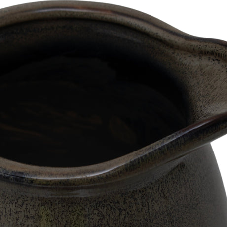 Close-up of the Hill Interiors Ceramic Olpe Vase 22cm in green, showing the wavy rim and mottled glaze pooling across the curved neck.
