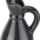 Close-up of Hill Interiors tall stoneware jug showing the pouring lip, curved handle and glossy navy-blue ceramic glaze against a white background.