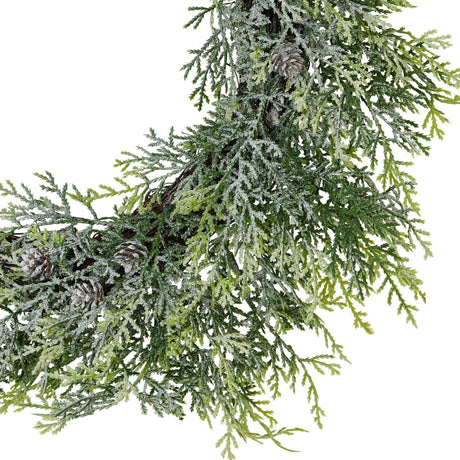 Close-up of Hill Interiors Frosted Pine Wreath with Pinecones in white, showing plastic pine foliage dusted with frost and small pinecones.