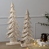 Hill Interiors Wood Large Christmas Tree in brown, two carved tiered timber trees with whitewashed grain on a wooden console with fairy lights.