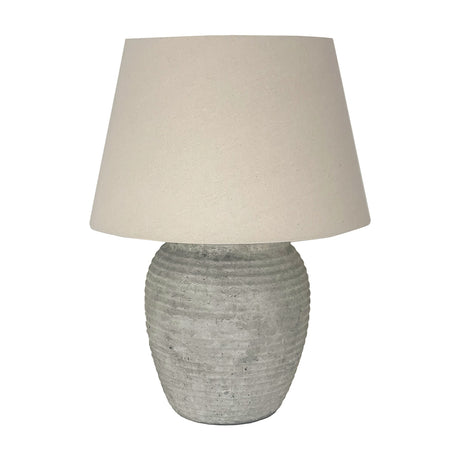 Hill Interiors ceramic table lamp with a ribbed grey rounded base and tapered beige drum shade, shown on a plain white background.