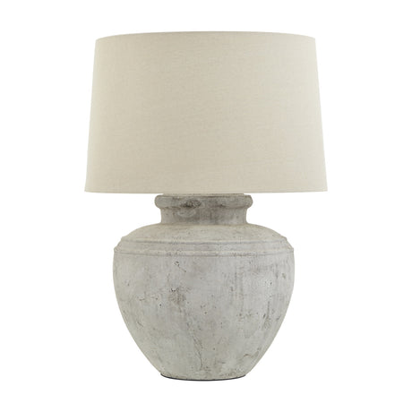 Hill Interiors Merenza ceramic table lamp with a rounded distressed white glazed urn-shaped base and tapered cream drum shade on a plain background.