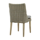 Hill Interiors Outdoor Dining Chair in beige with woven rattan-effect back and sides, grey seat cushion and tapered wooden legs, shown from the rear.