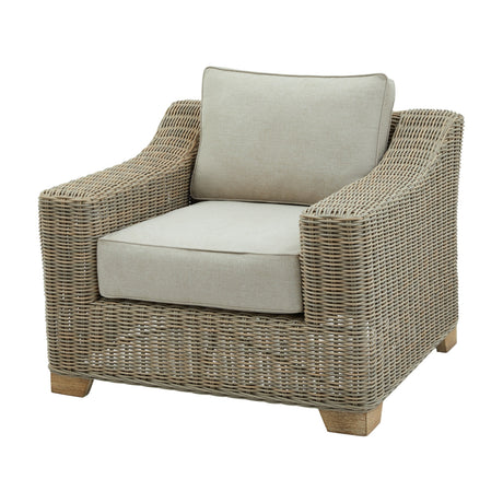 Hill Interiors Metal Outdoor Armchair in beige with woven sides, wooden block feet and neutral cushions on the seat and back, on a white background.