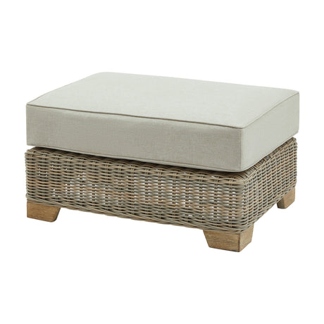 Hill Interiors Outdoor Foot Stool 81cm Wide in beige, with a woven rattan-effect base, wooden feet and a thick cushioned top on a white background.