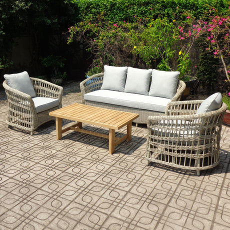 Hill Interiors Metal Outdoor Accent Chairs Set in beige with woven armchairs, three-seater sofa, grey cushions and timber coffee table on a garden patio.