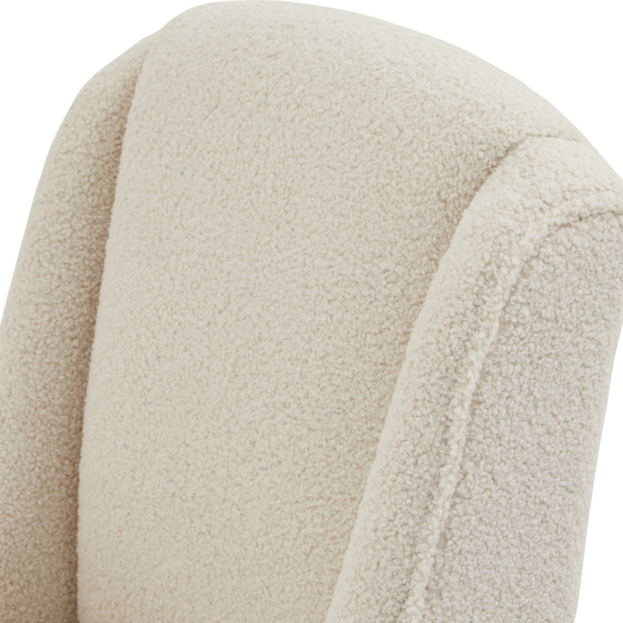 Close-up of the cream bouclé upholstery on the Hill Interiors Braxdon Dining Chair, showing the looped, nubby weave and softly curved backrest seam.
