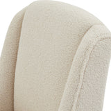 Close-up of the cream bouclé upholstery on the Hill Interiors Braxdon Dining Chair, showing the looped, nubby weave and softly curved backrest seam.