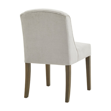 Hill Interiors Braxdon Upholstered Dining Chair in grey fabric with curved back and solid wooden legs, shown from the rear angle on a white background.