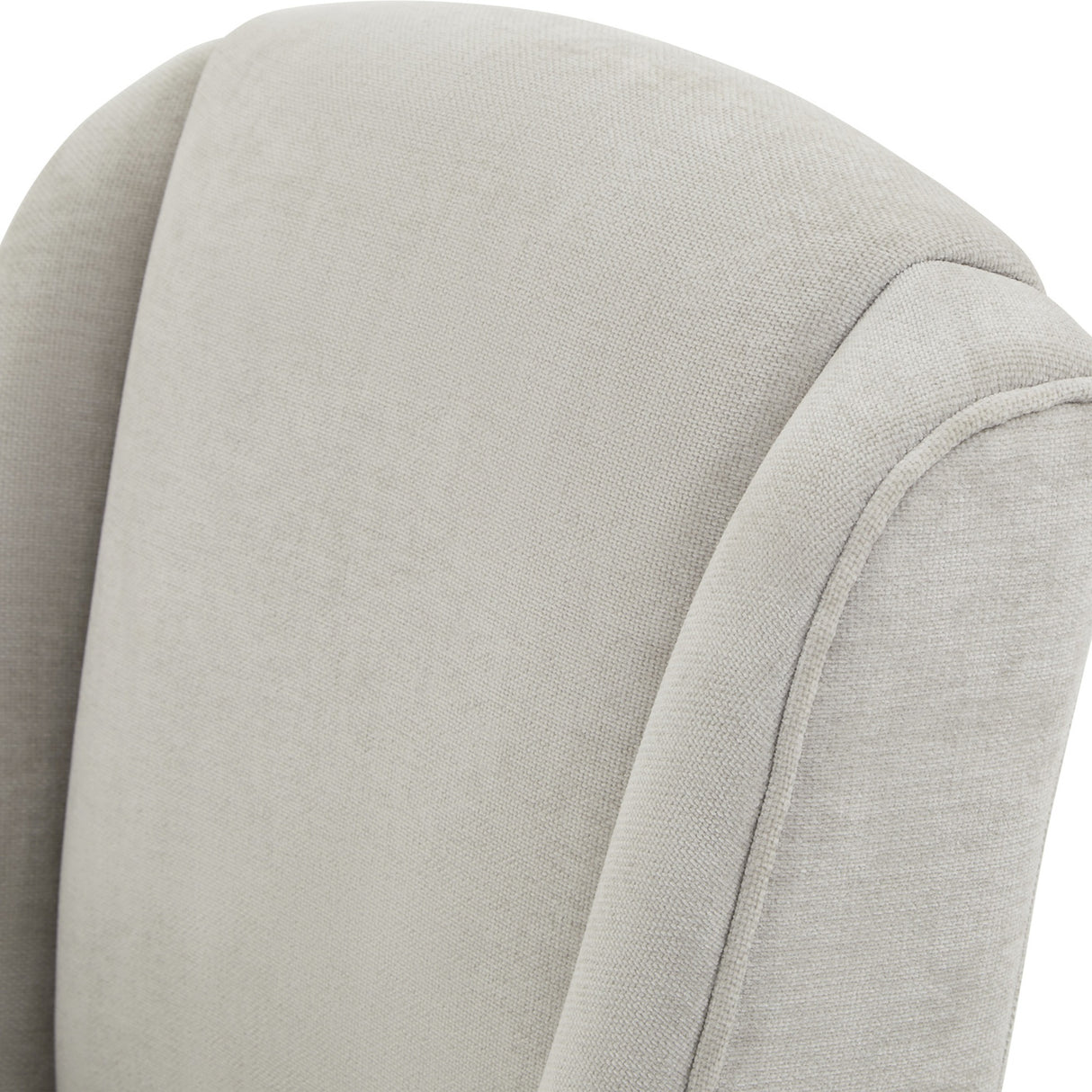 Close-up of the Hill Interiors Braxdon Upholstered Dining Chair in grey, showing the woven fabric texture and piped seam along the curved backrest.