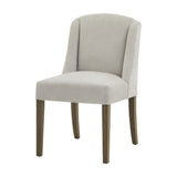 Hill Interiors Braxdon upholstered dining chair in grey fabric with a curved wingback and solid wooden legs, shown on a plain white background.