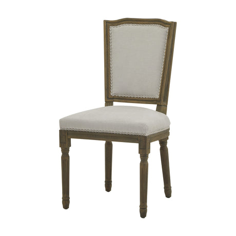 Hill Interiors Wooden Dining Chair in grey with a solid wood frame, upright nailhead-trimmed upholstered back and seat, on turned legs, plain background.