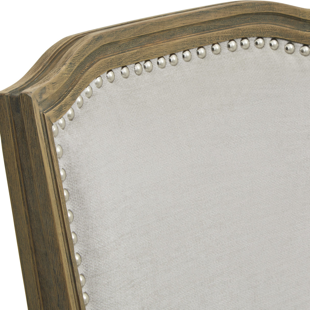 Close-up of Hill Interiors Wooden Dining Chair in Grey, showing the shaped wood frame, cream upholstered back and silver nailhead trim detailing.