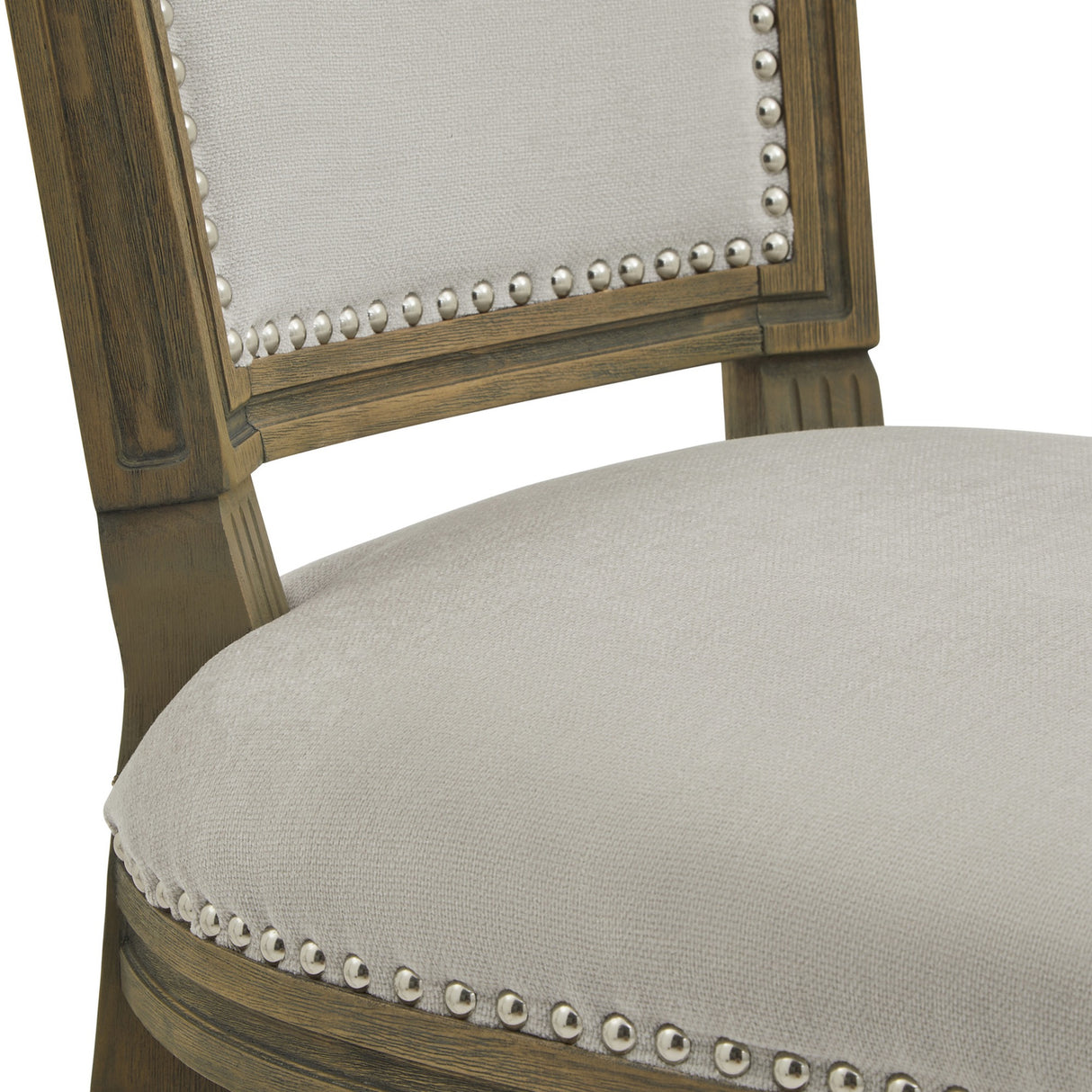 Close-up of Hill Interiors Wooden Dining Chair in grey, showing the upholstered seat and padded backrest with silver nailhead trim on a wood frame.