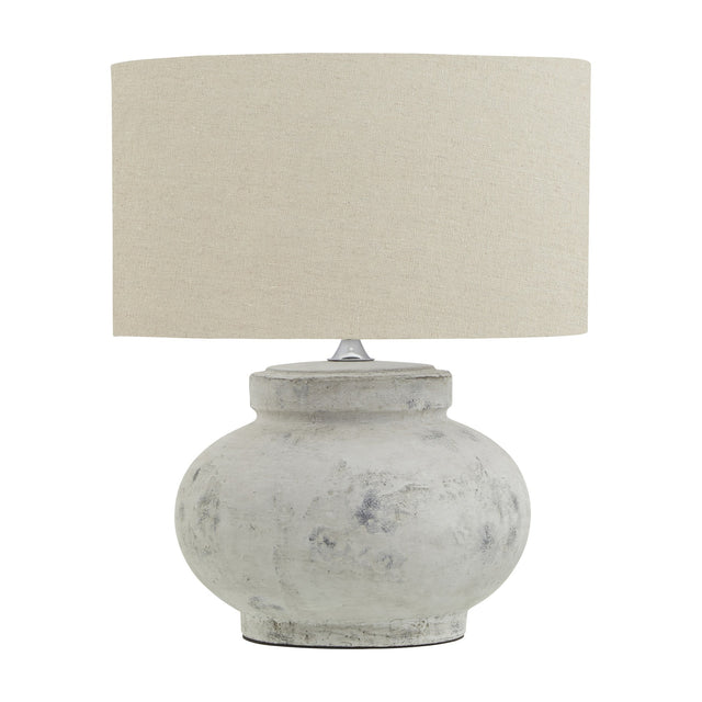 Hill Interiors Merenza squat ceramic table lamp with antique white glazed base and natural linen drum shade, shown on a plain white background.