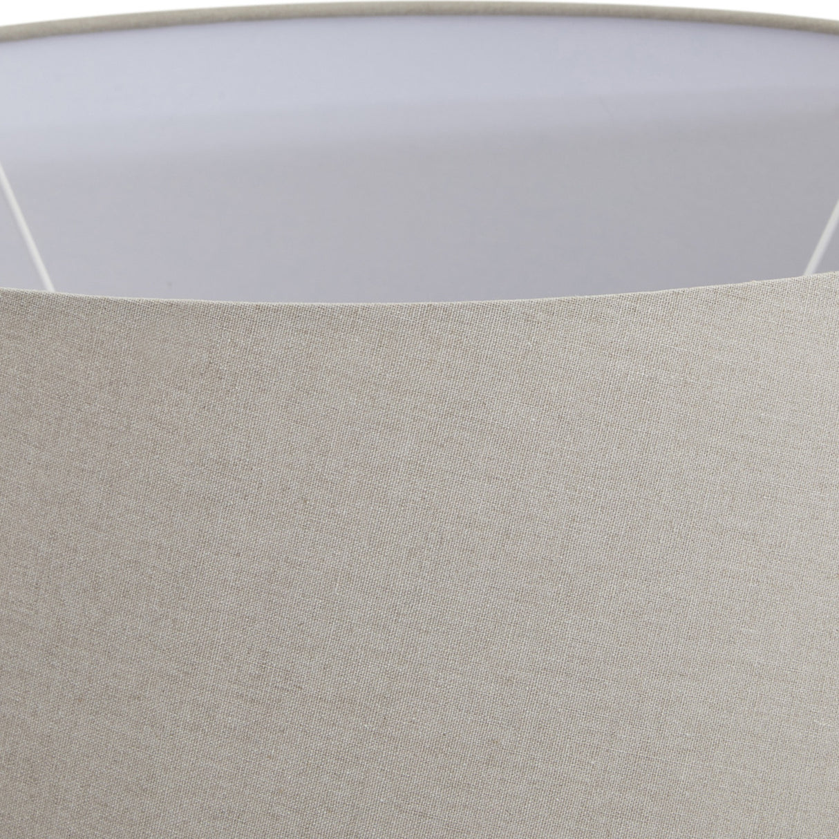 Close-up of the natural linen drum shade on the Hill Interiors Merenza table lamp, showing woven texture and white interior lining.