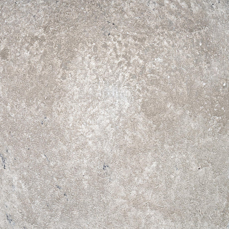 Close-up of the Hill Interiors Elvessa table lamp's ceramic base, showing the aged stone effect finish in beige with subtle tonal variation.