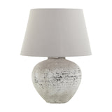 Hill Interiors Mestola large ceramic table lamp with a distressed beige stone-tone base and tapered cream drum shade on a plain white background.