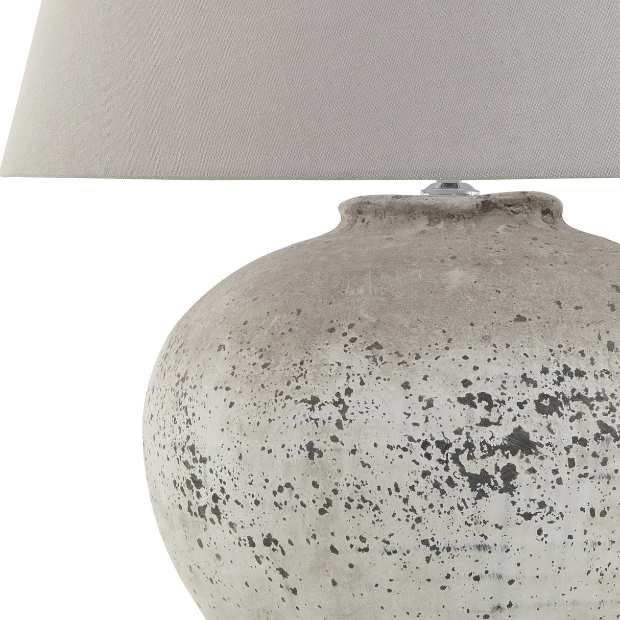 Hill Interiors Mestola large ceramic table lamp with a distressed beige stone-tone fluted base and neutral drum shade, shown on a plain white background.