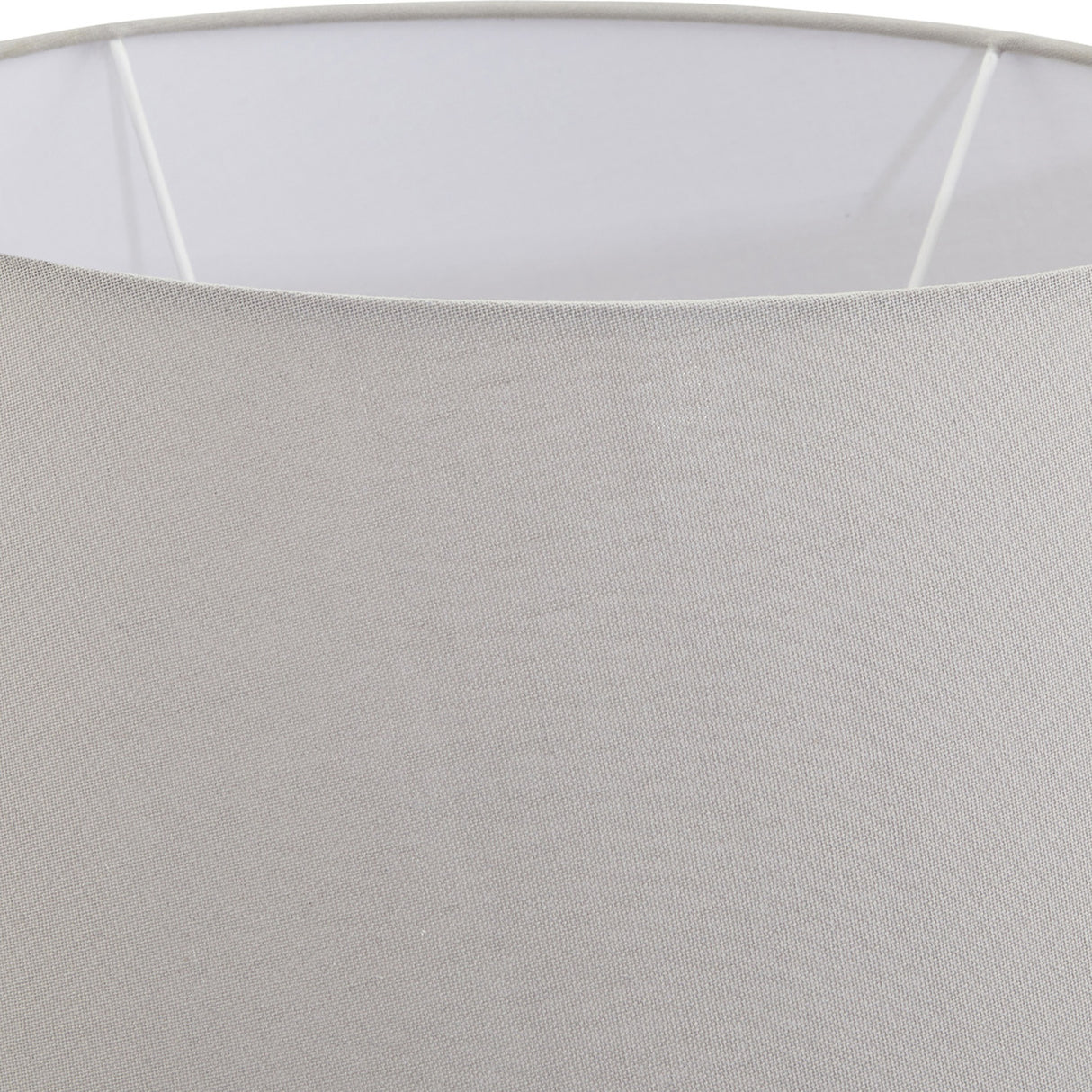 Close-up of the Hill Interiors Mestola large fluted ceramic table lamp showing the beige drum shade and smooth fabric weave against a light background.