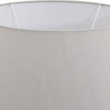 Close-up of the Hill Interiors Mestola large fluted ceramic table lamp showing the beige drum shade and smooth fabric weave against a light background.