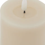 Close-up of the Hill Interiors Melt Effect LED Wax Candle in beige, showing the moulded pooled wax top and white flameless LED bulb wick.