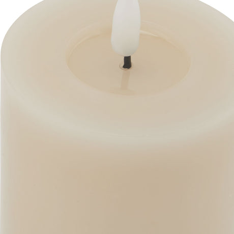 Close-up of the Hill Interiors Melt Effect LED Wax Candle in beige, showing the moulded pooled wax top and white flameless LED bulb wick.