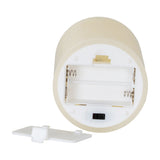 Underside of Hill Interiors Melt Effect LED wax candle in beige, showing two-cell battery compartment, on/off switch and detached cover.
