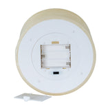 Underside of Hill Interiors Melt Effect LED Wax Candle in beige showing white plastic base, battery compartment with removable cover and on/timer switch.