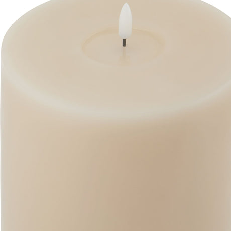 Close-up of the Hill Interiors Melt Effect LED Pillar Wax Candle in beige, showing the melted wax top edge and white LED flame tip.