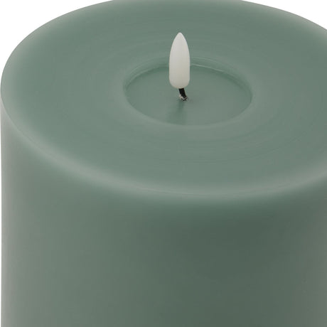 Close-up of the Hill Interiors Melt Effect LED Wax Candle in green, showing the matte wax surface, hollowed top and flameless LED flame tip.