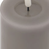 Close-up of the Hill Interiors Melt Effect LED Wax Candle in grey, showing the pillar's melted top edge and central LED wick.