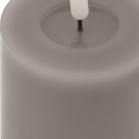 Close-up of the Hill Interiors Melt Effect LED Wax Candle in grey, showing the pillar's melted top edge and central LED wick.